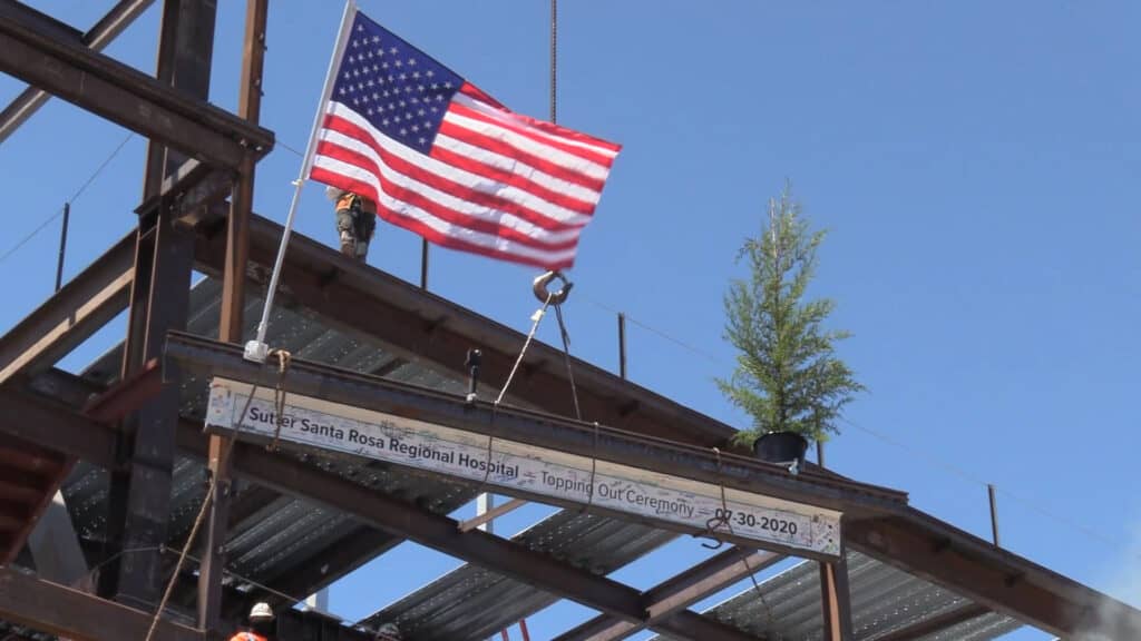 Sutter Health Santa Rosa Regional Hospital - Topping Out Ceremony - Final Beam being lifted into place with American flag waving in the breeze