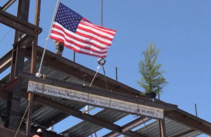 Sutter Health Santa Rosa Regional Hospital - Topping Out Ceremony - Final Beam being lifted into place with American flag waving in the breeze