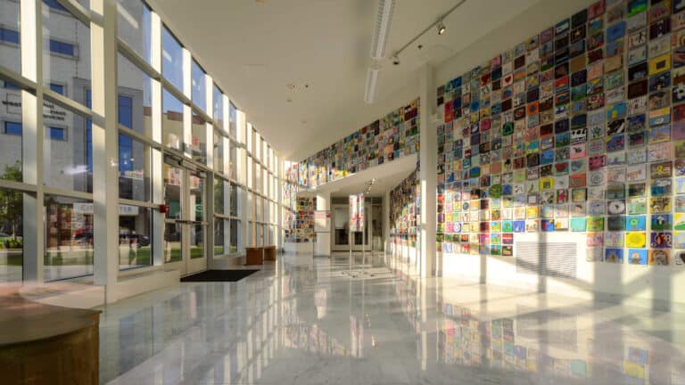 Trout Museum of Art - Interior View of Lobby with Wall of Art and Outdoors Visible