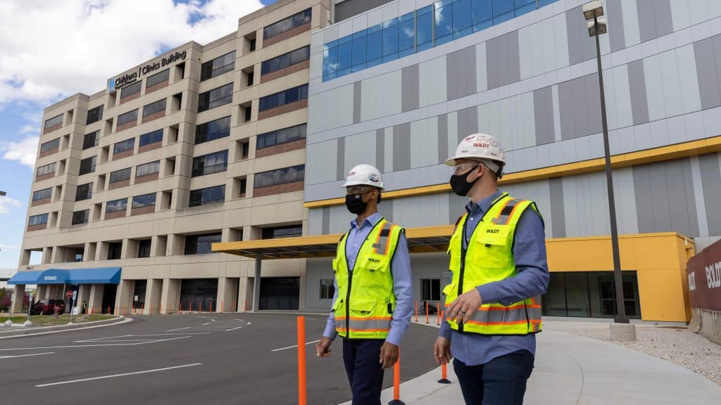 healthcare construction management employees outside medical office building construction site