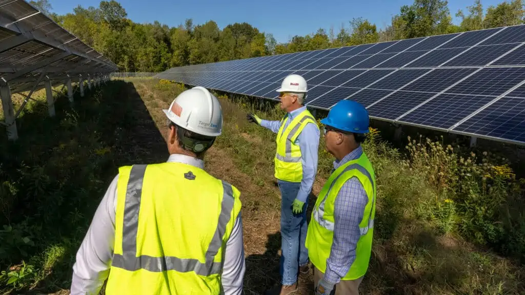 Three construction workers at Solar farm construction project