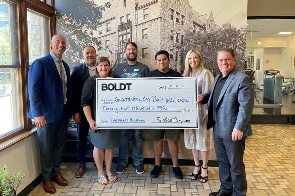 Boldt employees present an oversized check to the Greater Green Bay YMCA