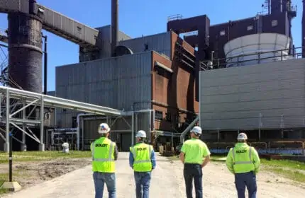 at central utility plant four boldt employees wearing neon vests facing towards central energy plant