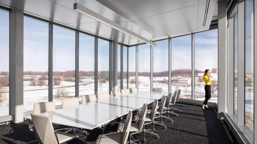 A completed conference room in office building with floor to ceiling windows from commercial general contractor services