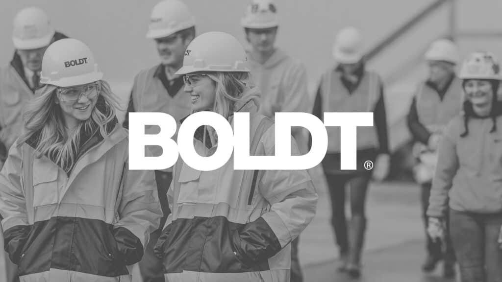 Boldt Logo on Black-and-white Image of Boldt Employees in Safety Apparel and Hard Hats