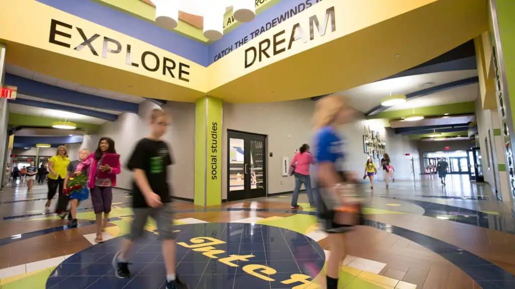 students walking through halls of education facility