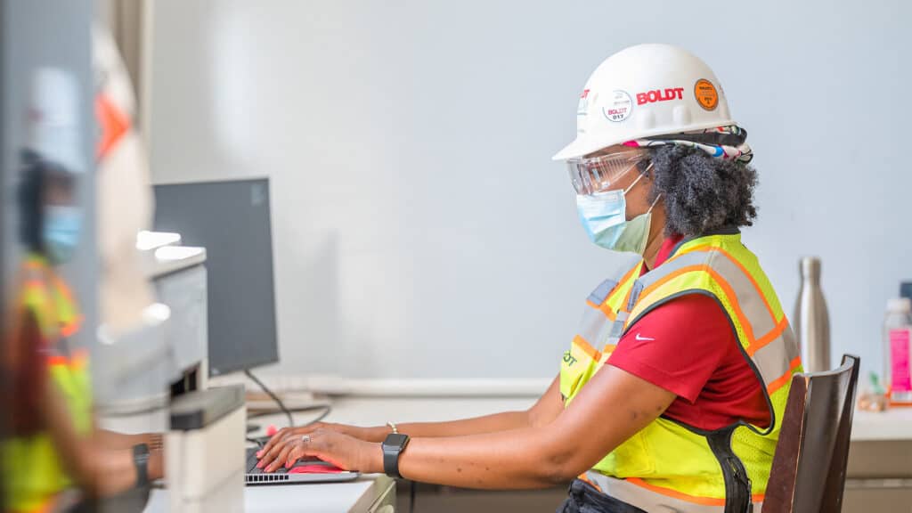 preconstruction services - female employee working on laptop