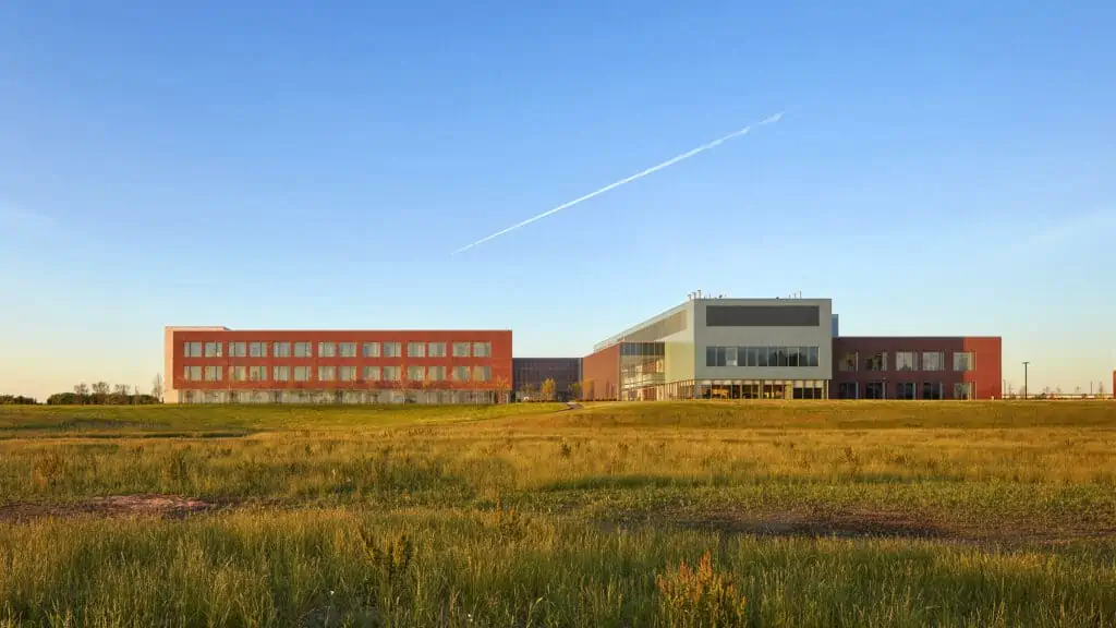 expansive field in front of modern medical facility