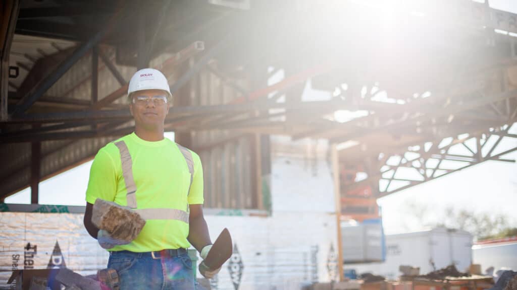 Boldt masonry worker holding cement brick