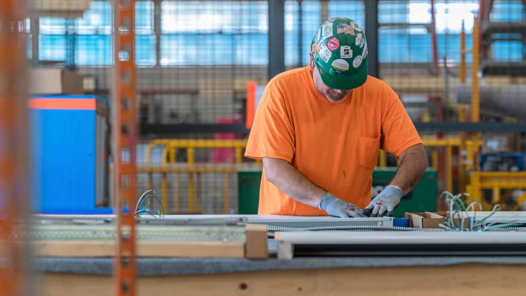 construction worker assembling electric fixtures