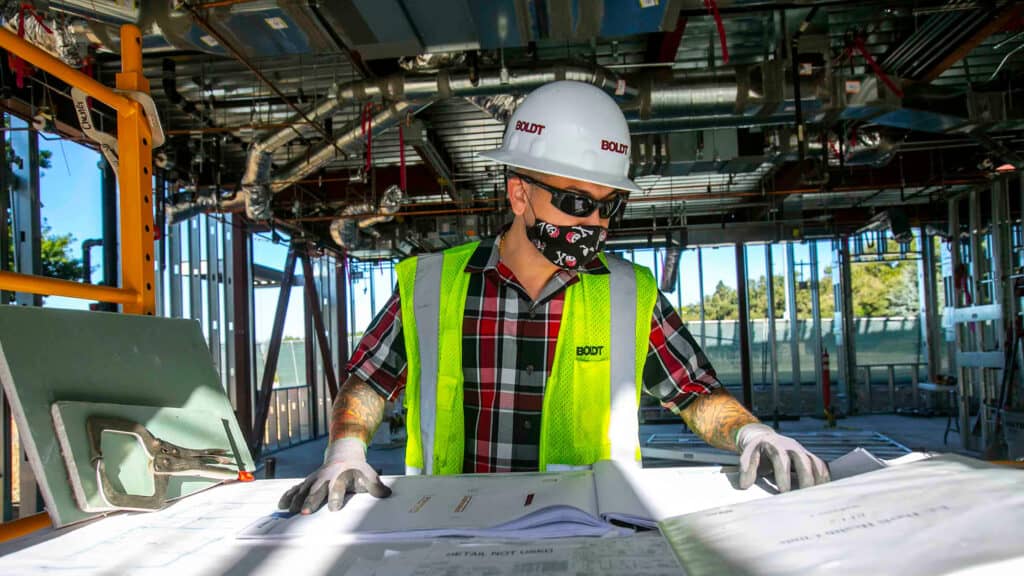 boldt technician looking over plans