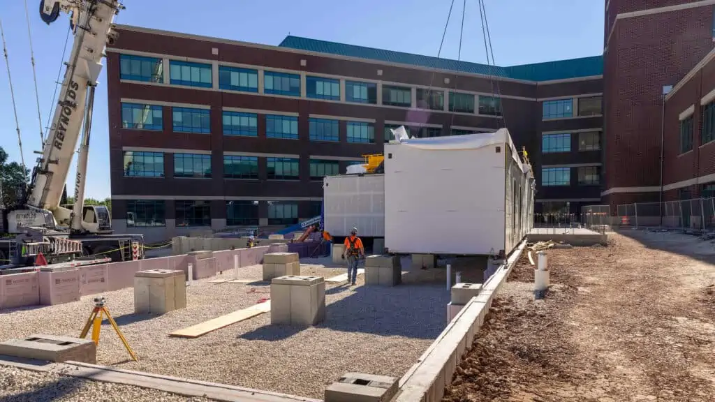 Boldt being a company leader in prefabricated and modular construction, holds modular unit being installed by crane outside a hospital