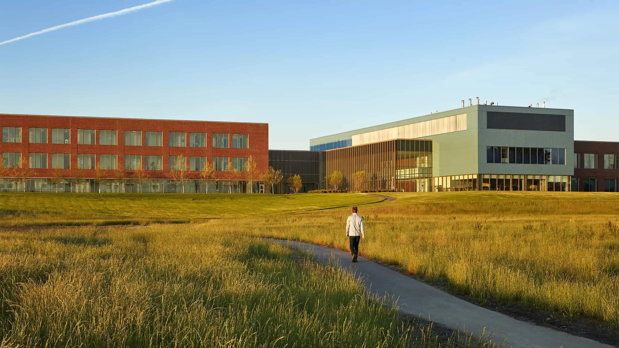 Pedestrian on walking path outside Aurora Southern Lakes