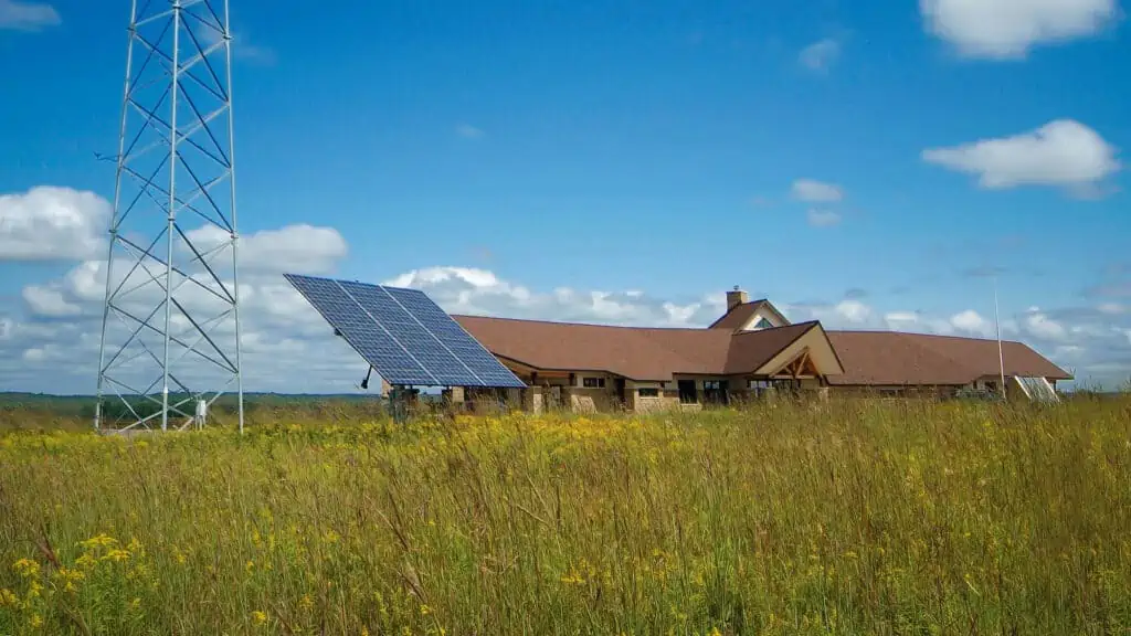 solar panel in field by nearby building