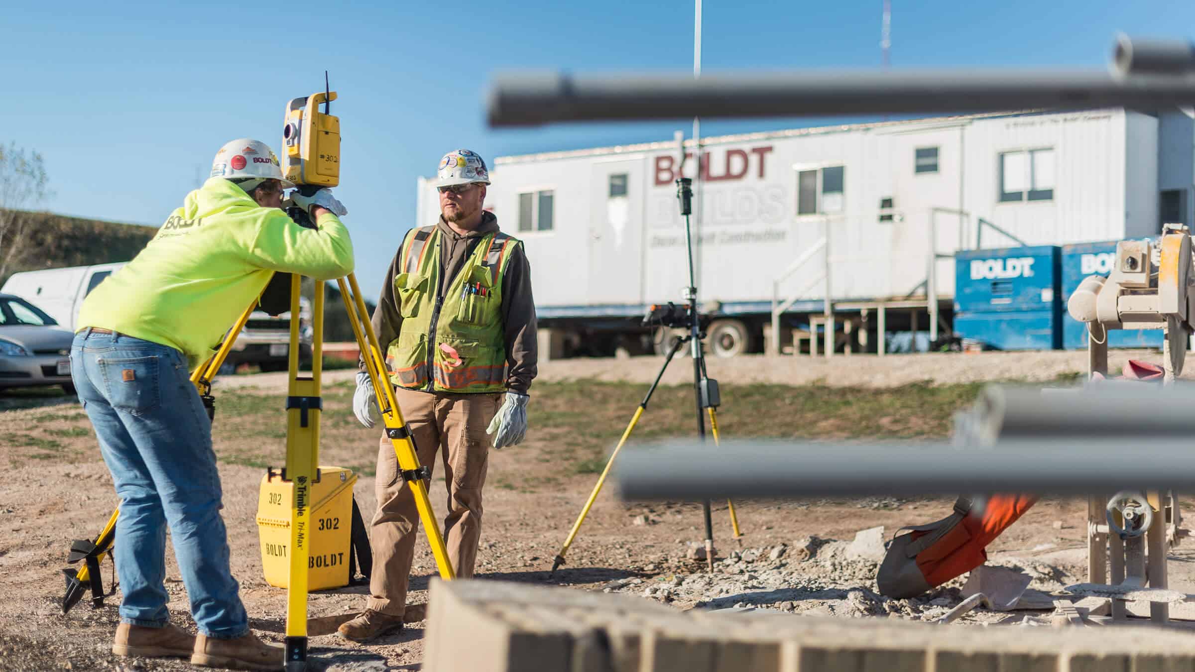 Construction employees surveying site as part of Virtual Design and Construction capabilities