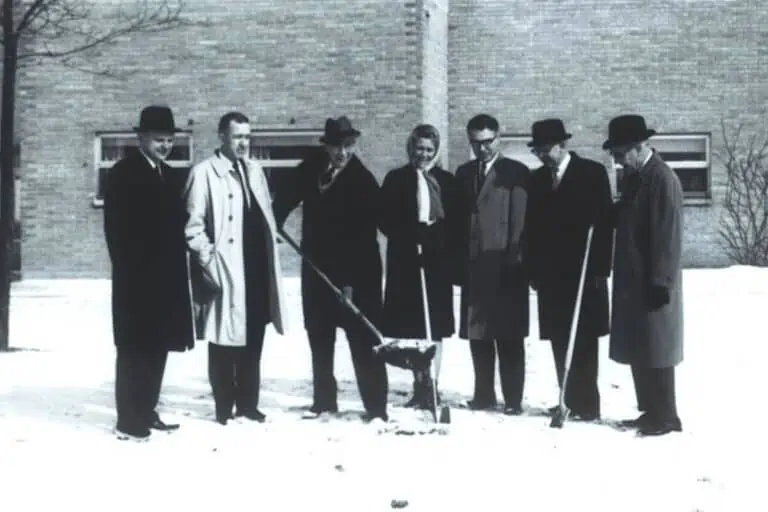 Black and white photo of people at groundbreaking
