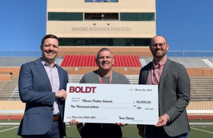 Boldt Oklahoma City employees present oversized check to Moore Public Schools