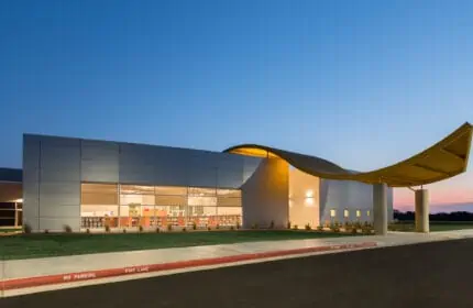 Broken Arrow Public Schools - Highland Park Elementary School Exterior on Site with Drive Lit at Night