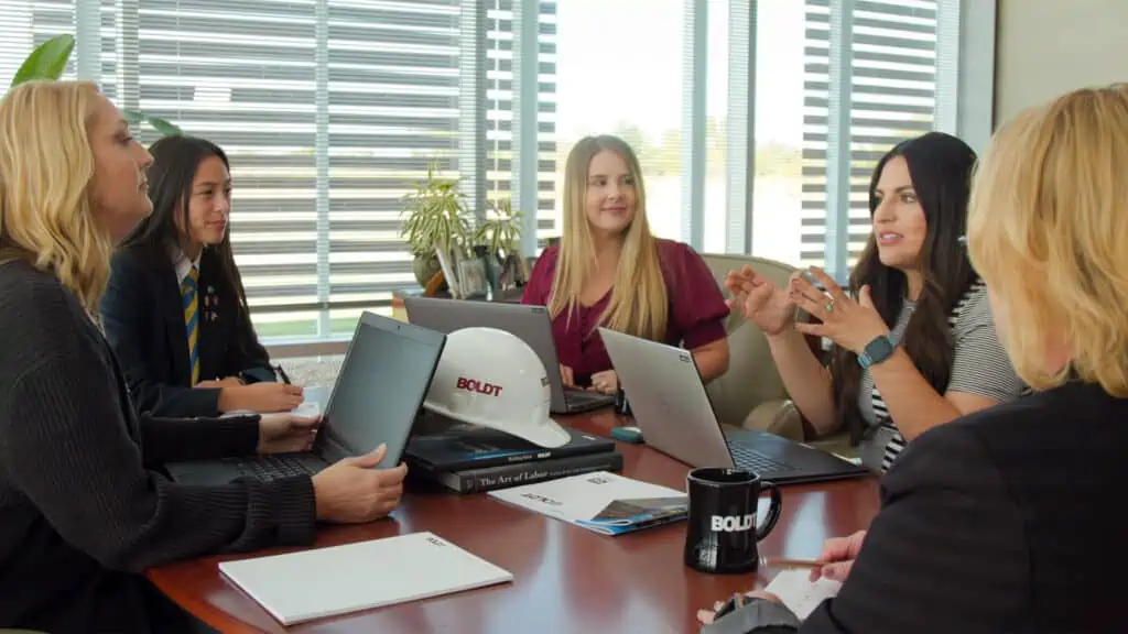 group of diverse business women working together in a conference room