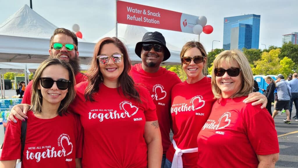 Group of boldt employees wearing matching shirts at an outdoor race-event