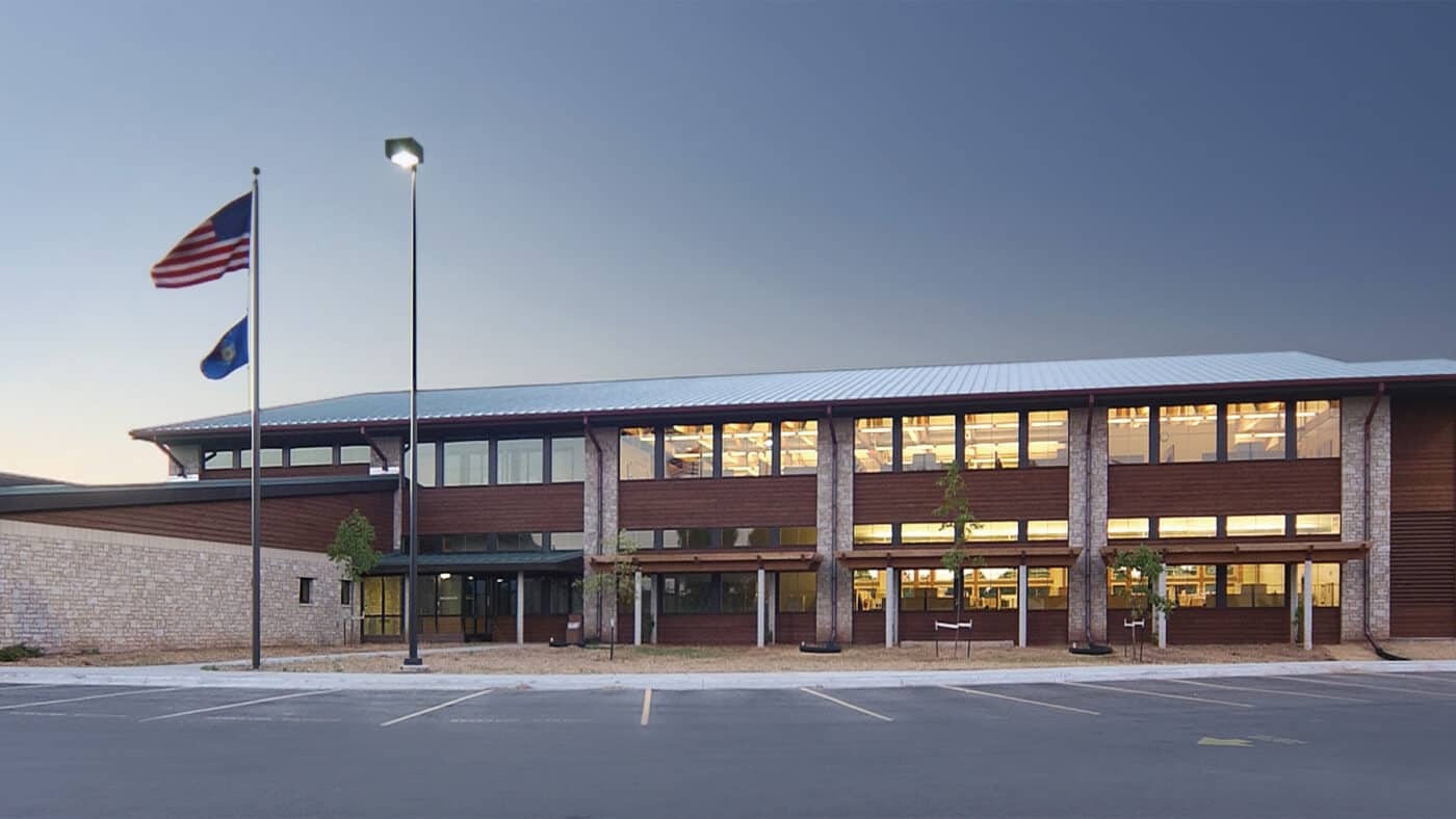 DNR Regional Headquarters and Service Center Exterior at Dusk with Parking Lot