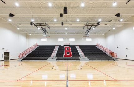 Moore Public Schools - Highland West Jr. High School Gymnasium Basketball Court and Bleachers