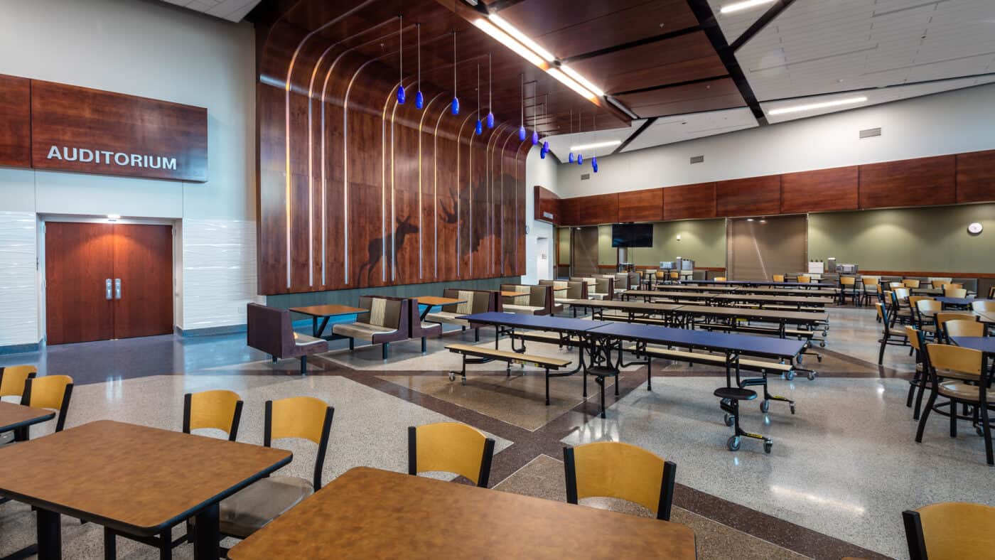 Moose Lake Community School Cafeteria with Mural Wall and Auditorium Entrance