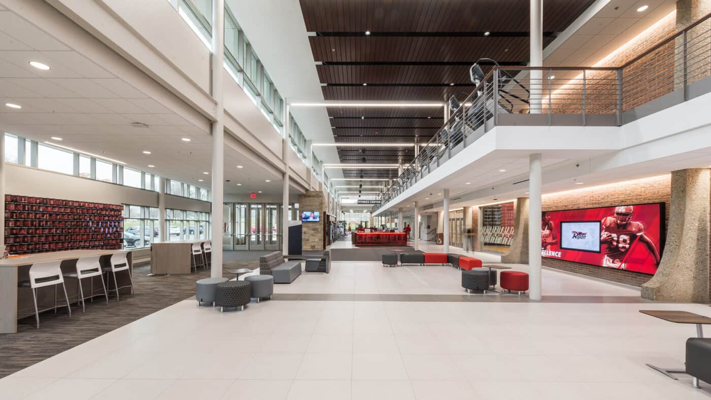 Ripon College - Athletic & Wellness Center Corridor with Seating, Mezzanine above with Elevated Fitness Equipment