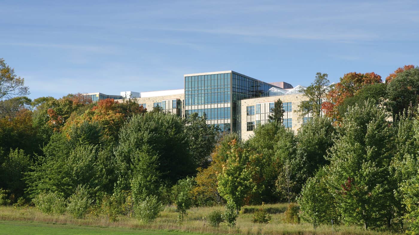 St. Olaf College - Regents Hall Exterior with Wooded Area in Foreground