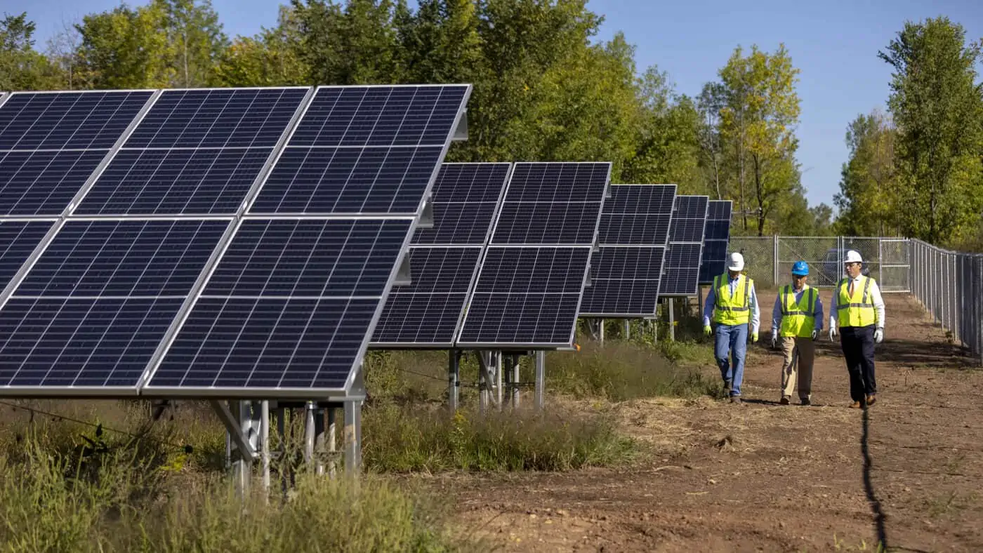 SunVest Solar - Chaska Solar Array Solar Panels with 3 People in Safety Vests Walking Alongside