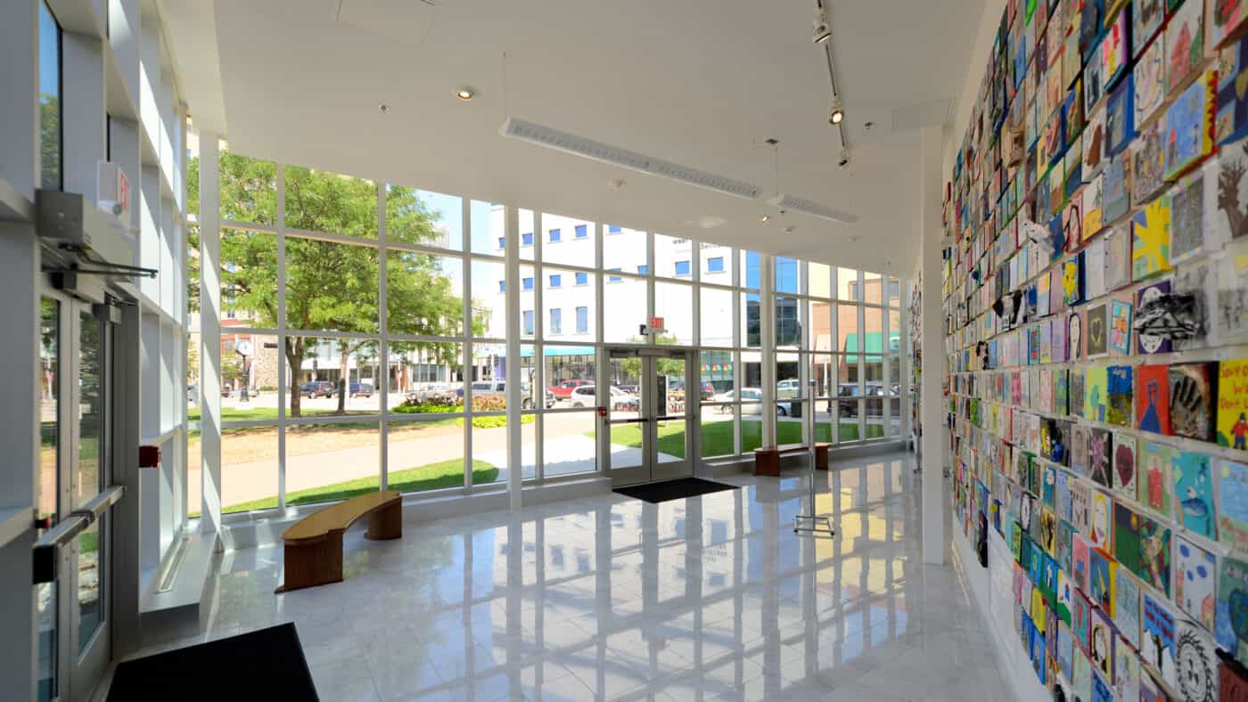 Trout Museum of Art - Interview View of Building Entrance with Wall of Art and View to Outdoors