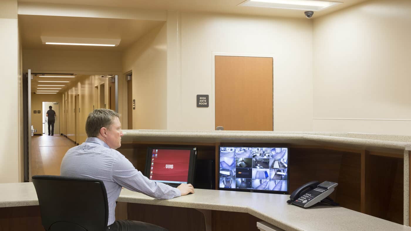 Universal Health Systems - Sierra Vista Hospital with Staff Member at Desk, Corridor in Background