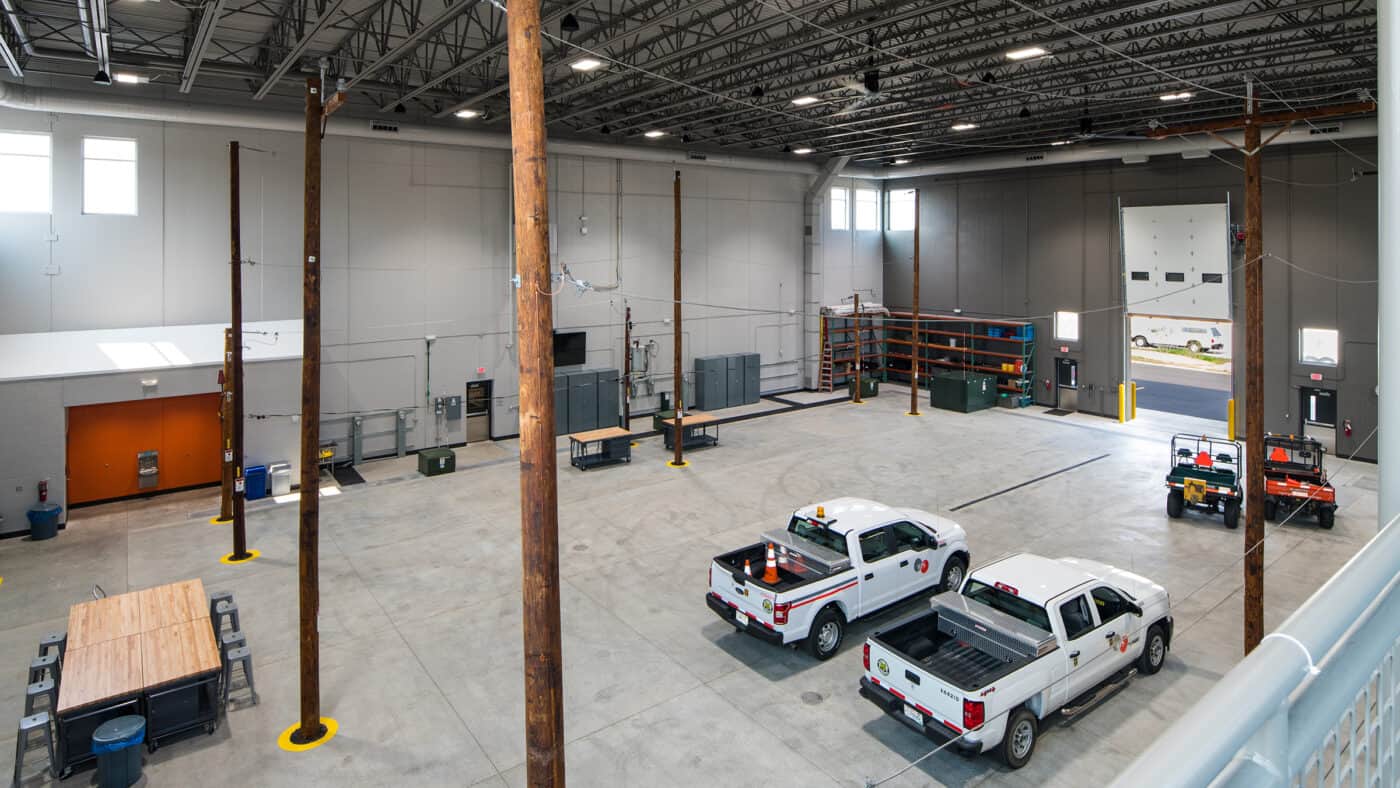 WEC Energy Group - Training Center - Interior View of Utility Poles in Training Center from Mezzanine, with Truck Bay and Overhead Doors Visible Below