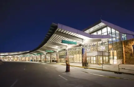 Will Rogers World Airport - Exterior View of Building Lit at Night, Exterior Overhang for Arrivals and Departures