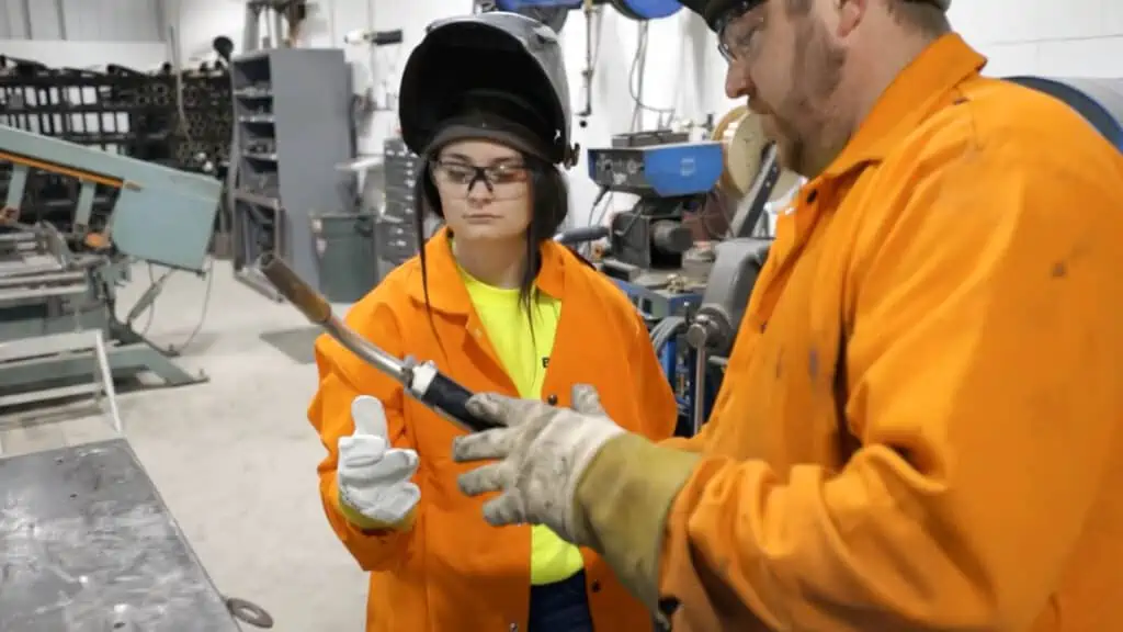 New apprentice construction worker learning how to weld