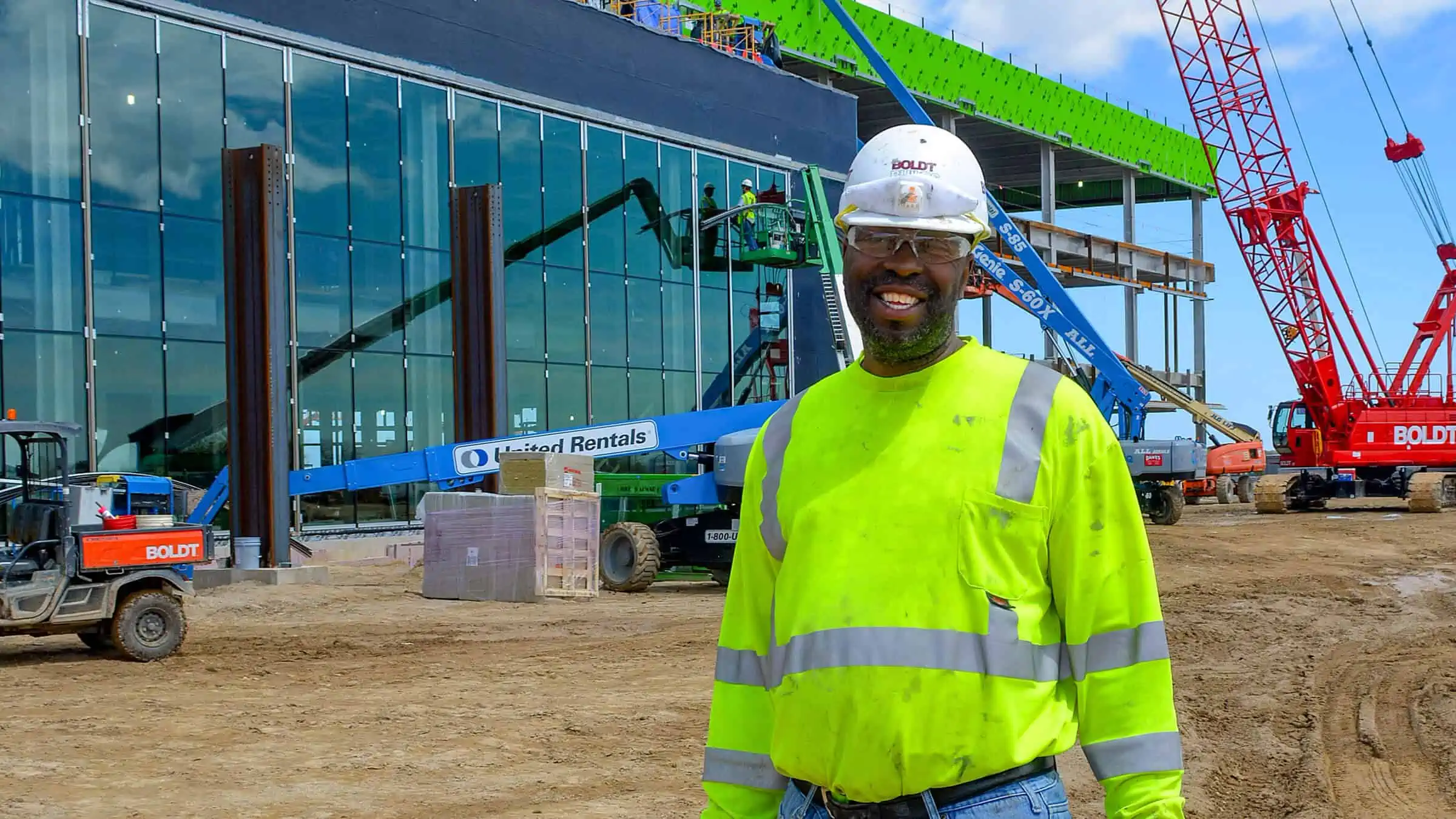 Construction worker standing in front of building project in development