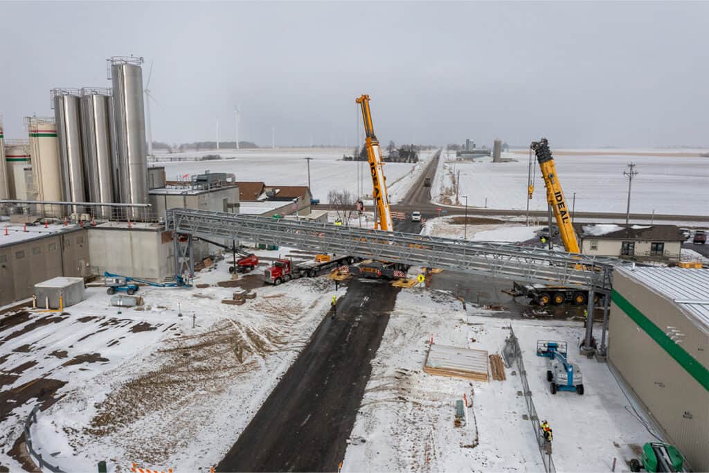 Cranes lifting bridge