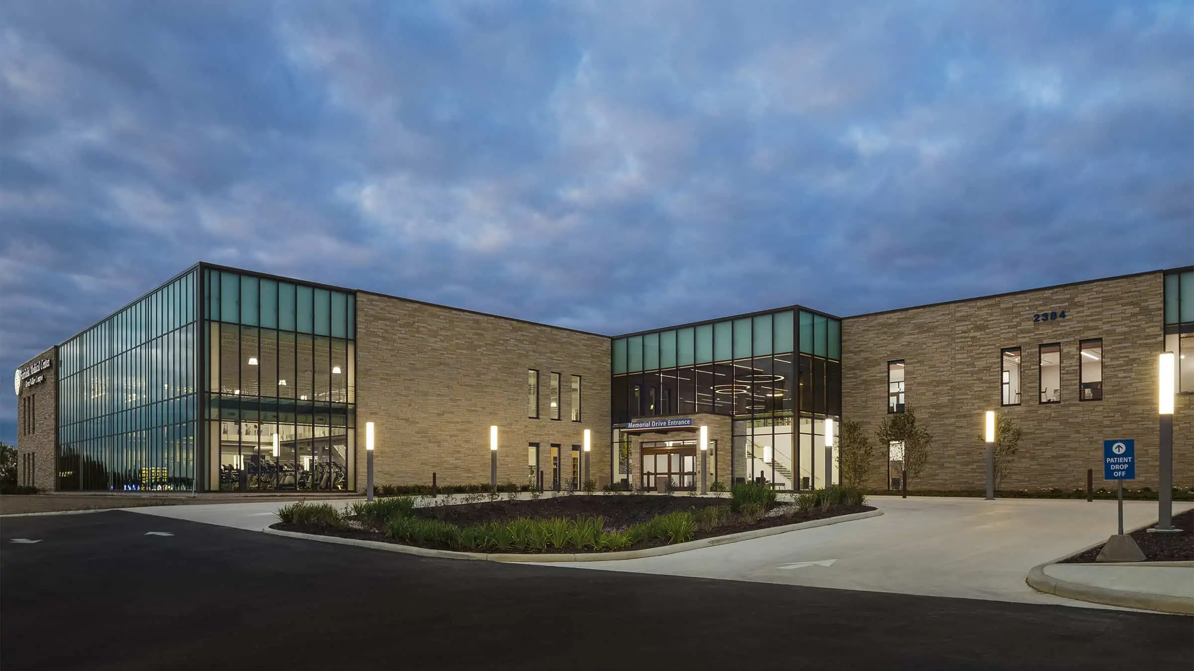 Fairfield Medical Center - exterior view of building with parking lot, building is lit at dusk